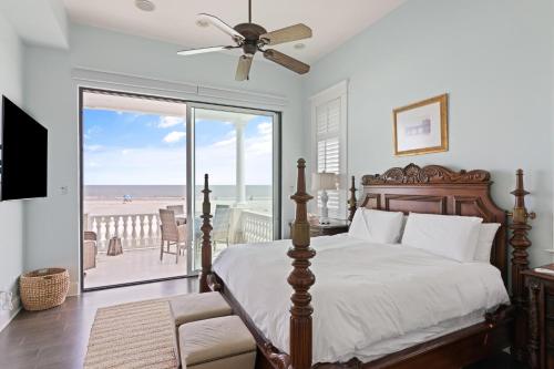 a bedroom with a bed and a view of the beach at Sea-Esta - 1136 Postell in East End