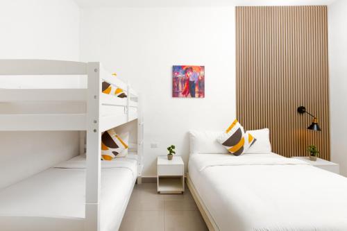 two bunk beds in a small room with white walls at Hotel H4 El Paraíso in El Paraíso