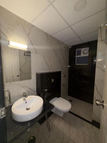 a bathroom with a sink and a toilet at Morden luxury studio in Jaipur