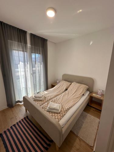 a bedroom with a bed and a large window at Una La Unica in Bihać