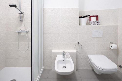 a bathroom with a shower and a toilet and a sink at Bella Vita Stays Happy in Sondrio