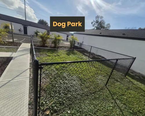 a dog park sign in front of a building at Walk to Stadium, 2 Parking spots, Dog Park, BBQ in Tampa