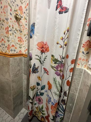 a shower curtain with butterflies on it in a bathroom at Interfaith 21st Street in New York