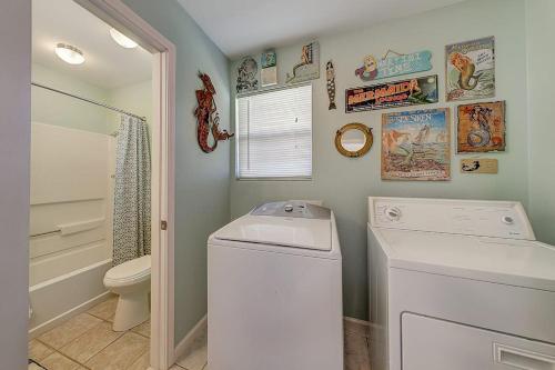 a laundry room with a washer and a toilet at Wharf Cottage in Rockport