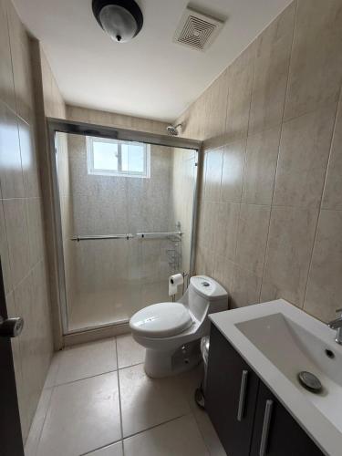 a bathroom with a toilet and a shower and a sink at An apartment with ocean views in Chiriquí
