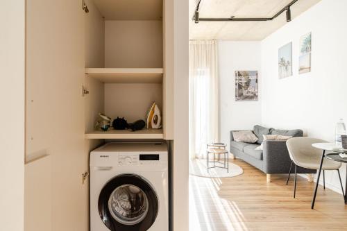 a washing machine in a living room with a couch at Yamas Urban Living Platinum Key in Limassol