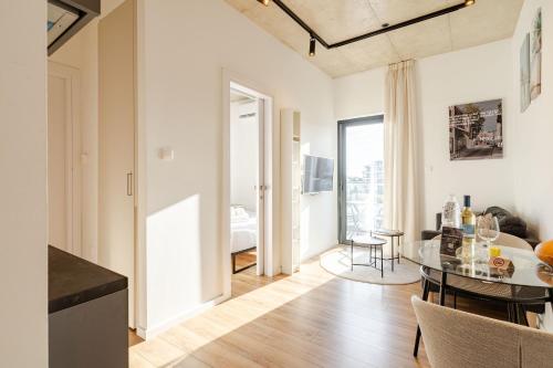a kitchen and living room with a table and a bedroom at Yamas Urban Living Platinum Key in Limassol