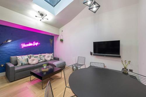 a living room with a couch and a table at The Acre Abode - Covent Garden - by Frankie in London