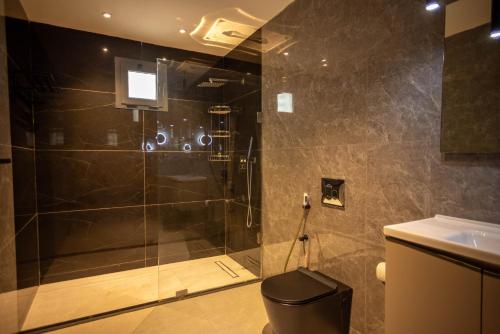a bathroom with a shower with a toilet and a sink at Hillside hotel in Kenema