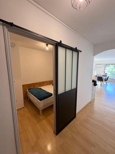 a sliding glass door in a room with a bed at Studio Hyeres sur le port in Hyères
