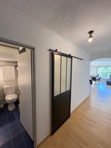 a bathroom with a toilet and a door in a room at Studio Hyeres sur le port in Hyères