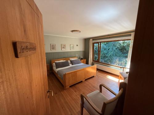 a bedroom with a bed and a large window at Amadeus Hotel Boutique in Frutillar