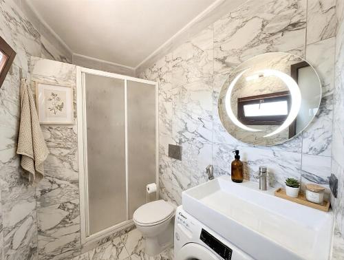 a bathroom with a toilet sink and a mirror at DaVilla Sanremo - Entire Villa, Sea View & Pool in Pampara