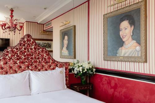 a bedroom with a bed and a portrait of a woman at Rubens At The Palace in London