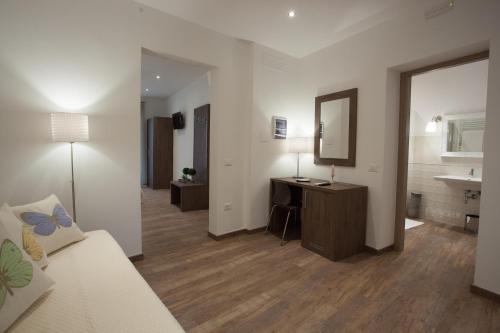 a living room with a desk and a sink at Magnifica Luxury Suites in Assisi