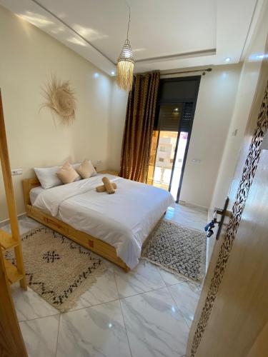 a bedroom with a bed with a teddy bear on it at Atlantic Coast Imsouane in Imsouane