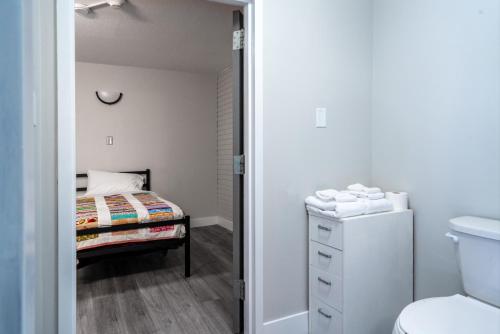 a small bedroom with a bed and a bathroom at Nekinan Lodge in Smoky Lake