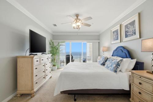 a bedroom with a bed and a flat screen tv at Marlin Key 2D in Orange Beach