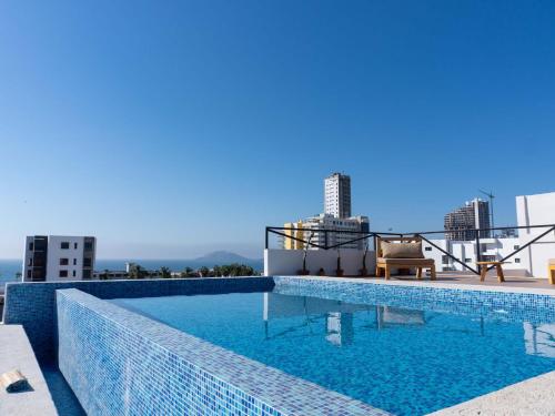 a swimming pool on the roof of a building at Rooftop Pool & Steps to the Beach in Mazatlán