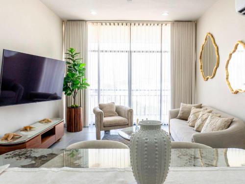a living room with a couch and a table at Rooftop Pool & Steps to the Beach in Mazatlán