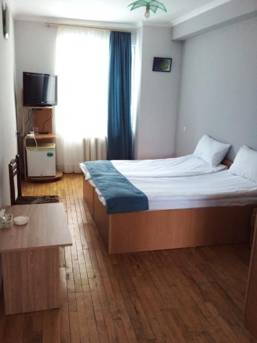 a bedroom with a large bed and a window at NR Rest House in Tsaghkadzor