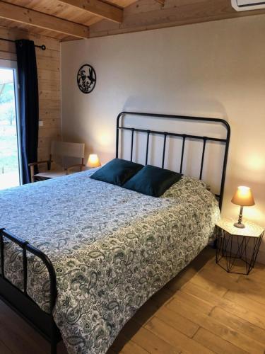a bedroom with a bed and a clock on the wall at Le colibri des prés in Maurens