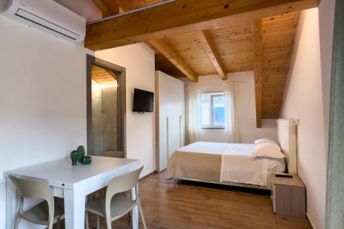a bedroom with a bed and a table and chairs at Cilento Sea Rooms in Agropoli
