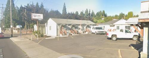 a parking lot with white trucks parked in it at Madison Suites Motel in Portland