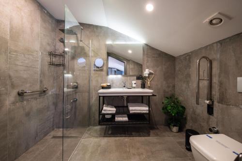 a bathroom with a sink and a shower at Skopea Inn Exclusive Hotel in Göcek