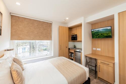 a bedroom with a bed and a window at NOX Kensington in London