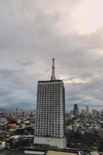 a tall building with a tower on top of it at MDM Staycation by SMDC in Manila