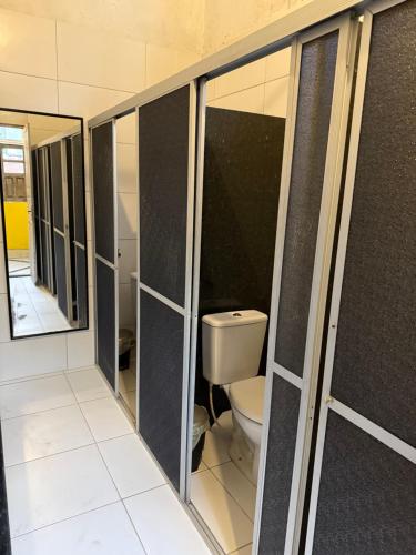 a bathroom with a toilet and some stalls at Sobrado Antonieta in Belém