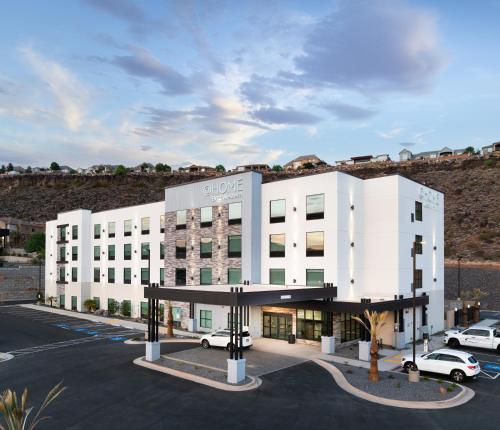 a large white building with cars parked in a parking lot at @HOME by Best Western St. George in St. George
