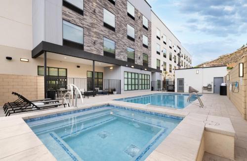 a swimming pool in front of a building at @HOME by Best Western St. George in St. George