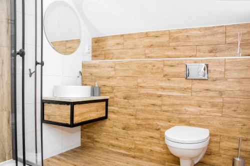 a bathroom with a toilet and a sink at Apartamenty Suchacz in Suchacz
