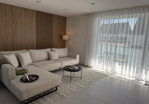 a living room with a couch and a large window at JAM Suite in Koblenz
