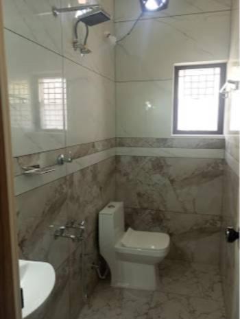 a bathroom with a toilet and a sink and a window at Dream Stay in Varkala