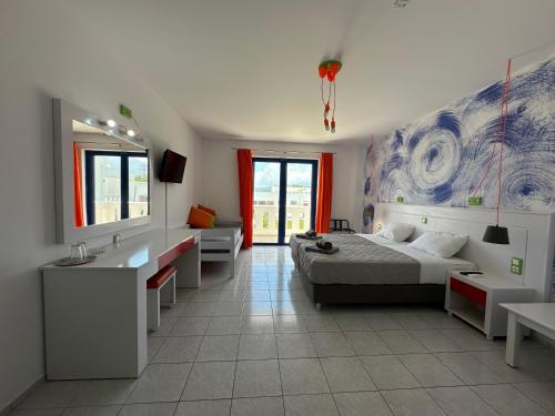 a bedroom with a bed and a sink and a mirror at Bouradanis Art Hotel in Marmari