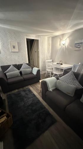 a living room with two couches and a table at No 4 Devon Square in Kingsbridge