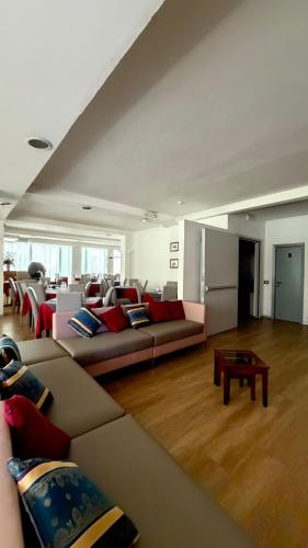 a living room with a couch and a table at Hotel Gattei in Rimini