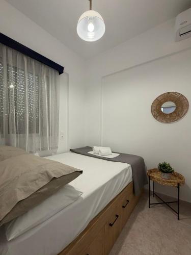 a bedroom with a large bed and a window at Stegna Sunny-Beach in Archangelos