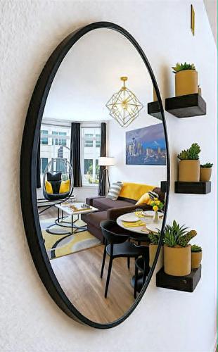 a mirror hanging on a wall in a living room at Vibrant City Gem/99 Walk/Pike Pl/Pool/Pet/Parking in Seattle