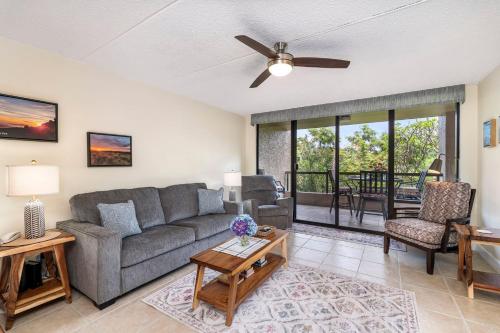 a living room with a couch and a ceiling fan at Kona Pacific C317 in Kailua-Kona