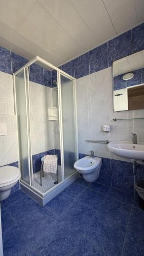 a bathroom with a shower and a sink and a toilet at Hotel Gattei in Rimini
