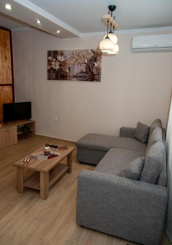 a living room with a couch and a coffee table at Maria's Sweet Home in Chios