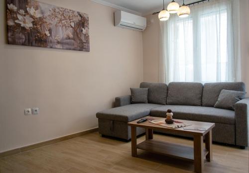 a living room with a couch and a coffee table at Maria's Sweet Home in Chios