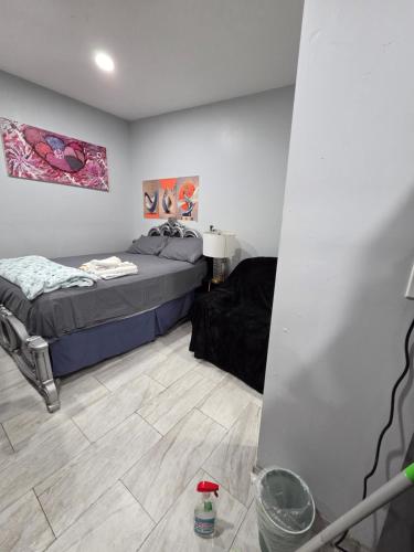 a room with two beds and a table in it at Newly built Studio in Irvington