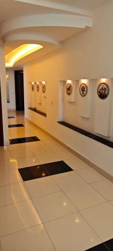 a hallway with paintings on the walls of a building at Dar Essaada - Exceptionel duplex de 270 M2, plage à 2 min à pieds in Mahdia