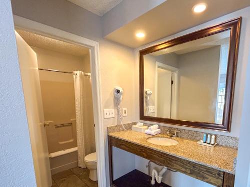 a bathroom with a sink and a mirror at Park Lane Motel in Lake George