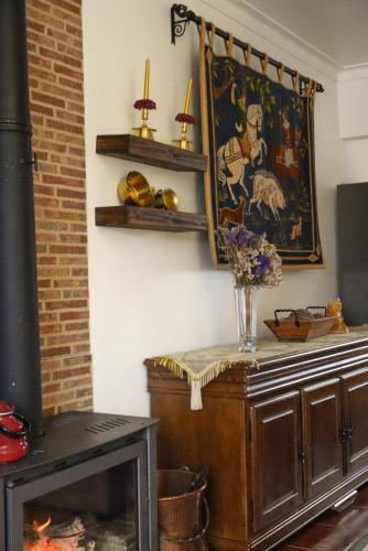 a living room with a fireplace and a painting on the wall at O Cantinho do Pedro in Tolosa